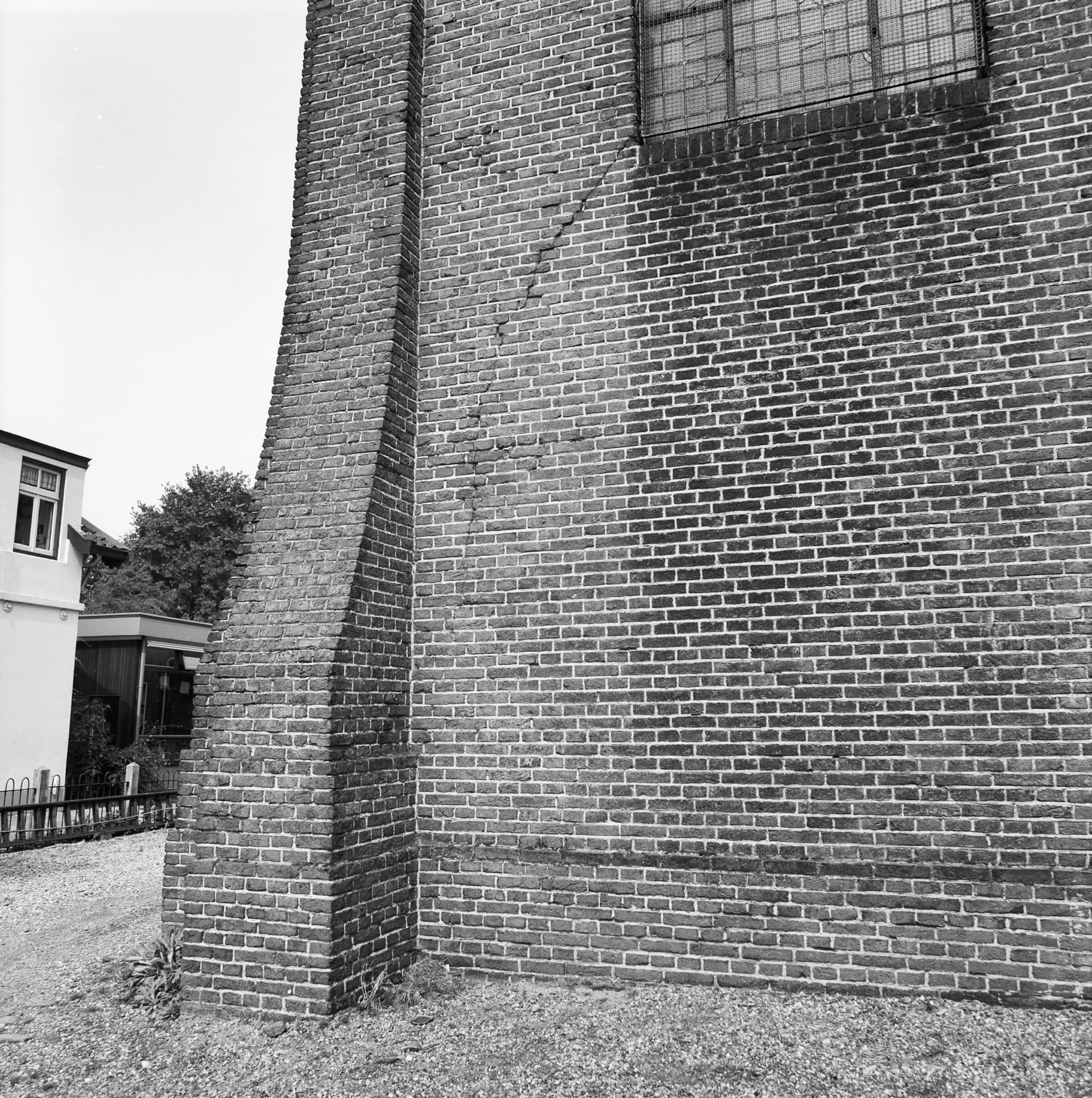 Diagonal crack through a brick facade, a common settlement sign