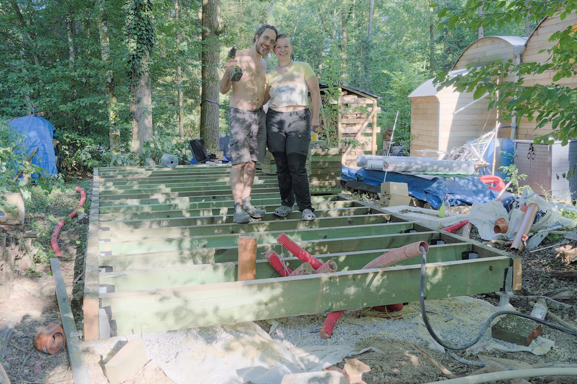 Crew installing helical piles for a timber-frame shed foundation