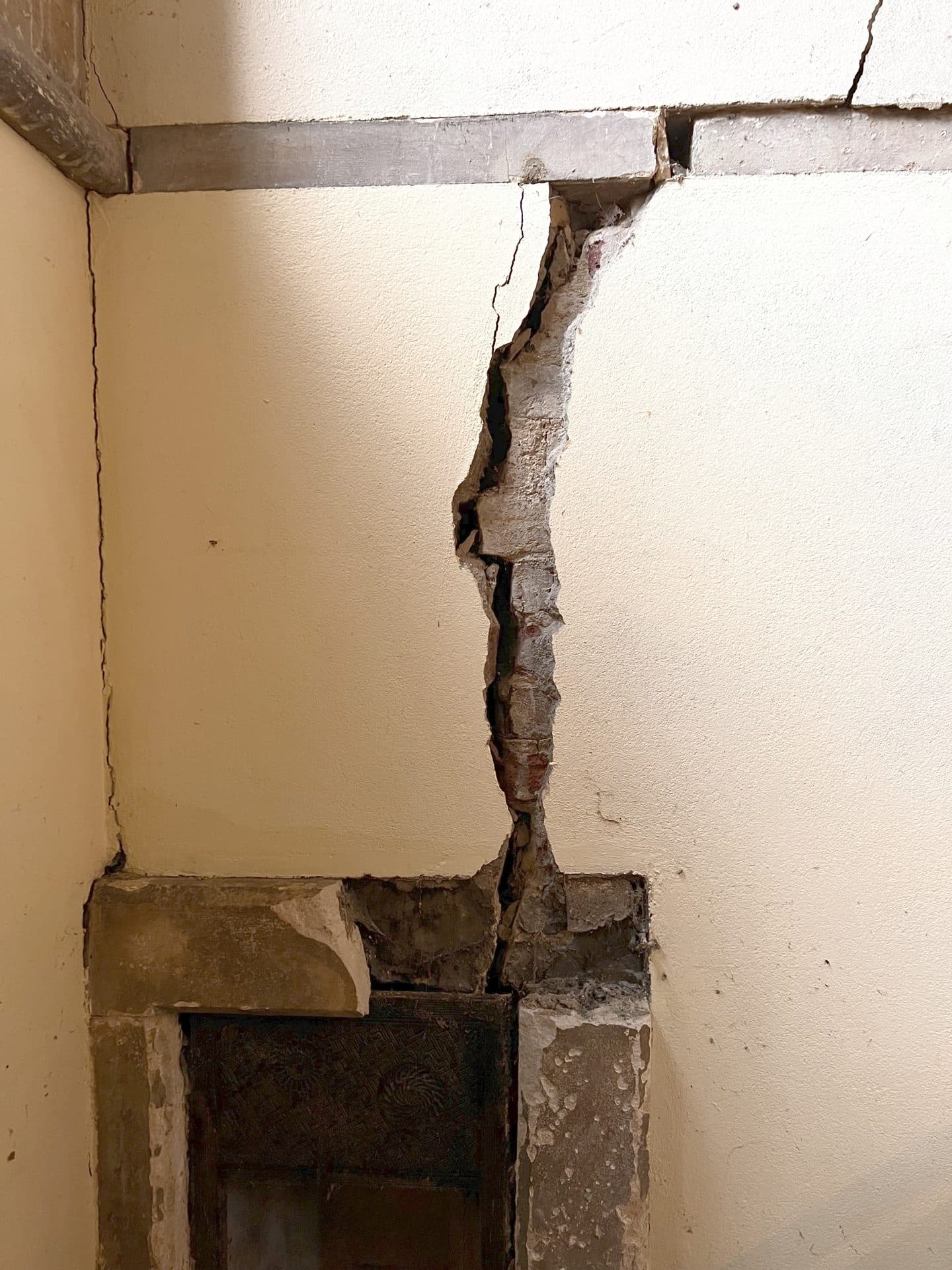 Interior wall crack above a fireplace
