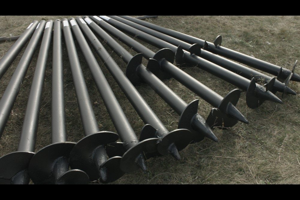 Helical piles supporting a structure at grade